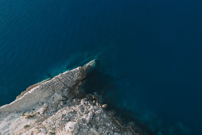 Blue sea waving near stony shore