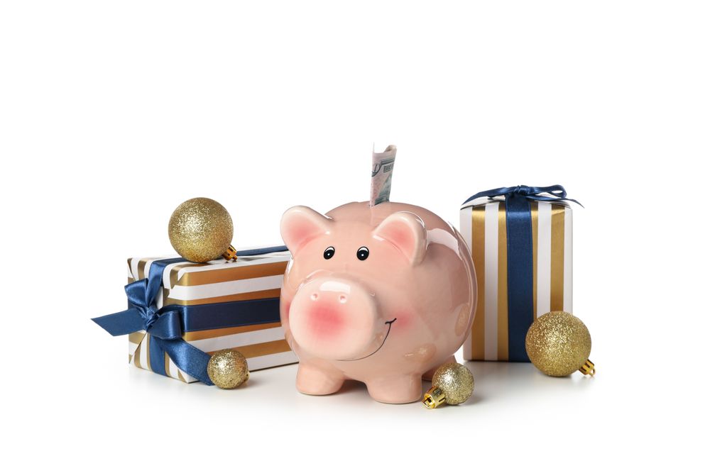Concept of Christmas finance with piggy bank, isolated on light background