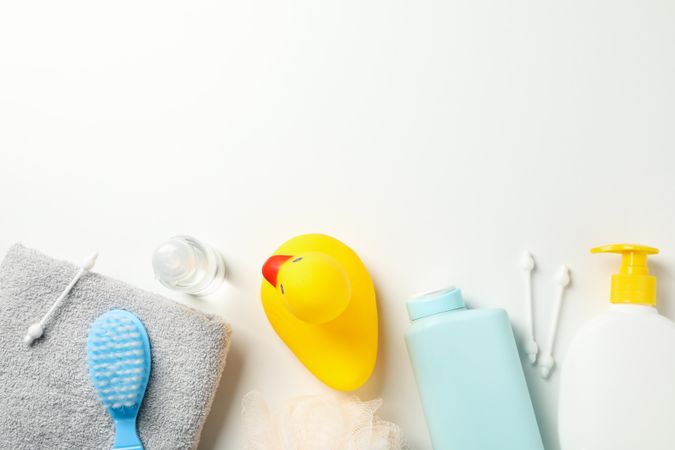 Baby hygiene accessories on light background, top view and space for text