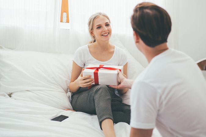 Man giving a gift box to his girlfriend