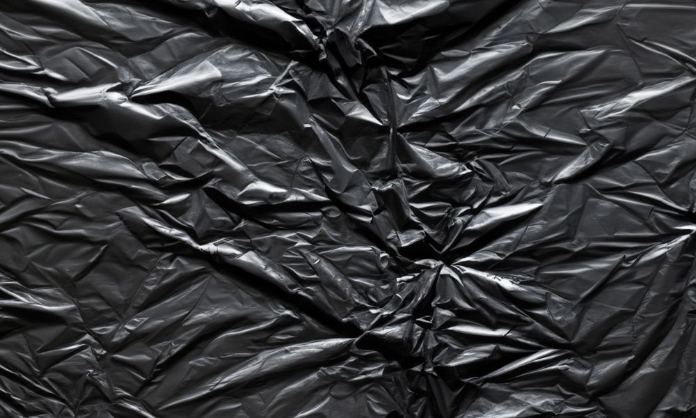 dark crumpled and creased plastic poster texture background
