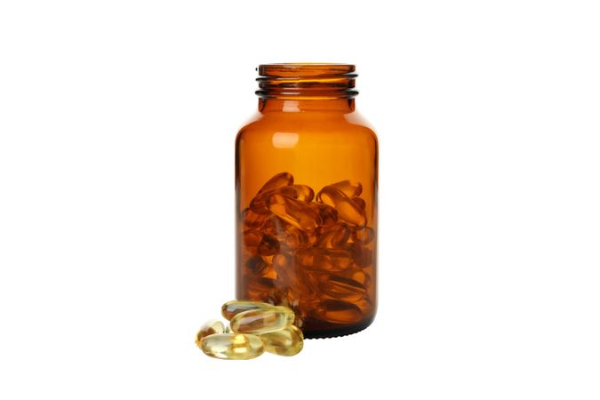 Brown bottle with omega pills, isolated on blank background