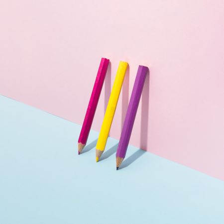 School pencils leaning on pastel background