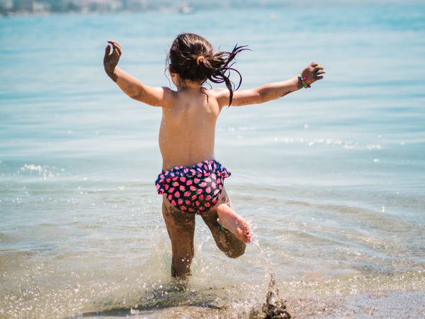 Cheerful girl having fun in warm sea