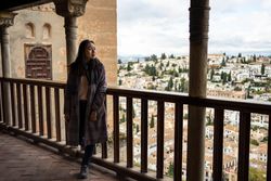 Cheerful woman visiting ancient city
