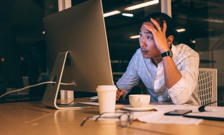 Entrepreneur looking tensed while working late in office