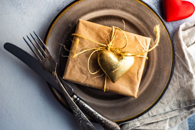 St Valentine day table setting with gift and gold heart