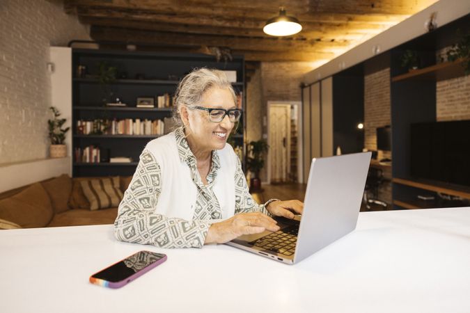 Older woman using laptop at home