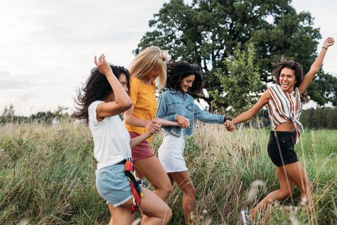 Group of four young women outside in the park
