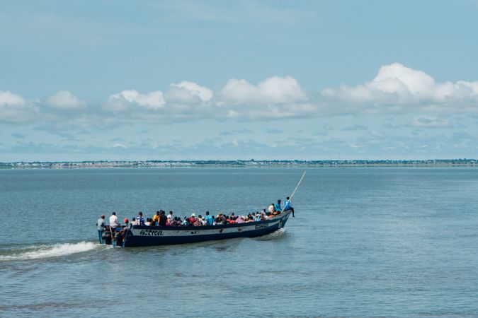 People riding on boat on sea during daytime