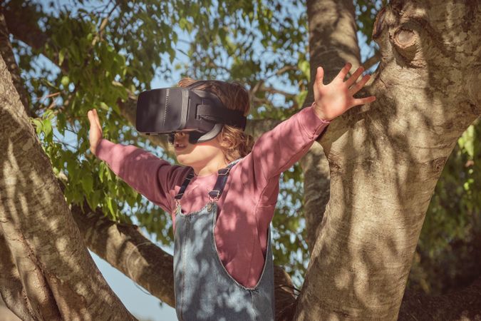 Boy in VR goggles on sunny day