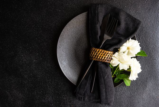 Minimalistic table setting with flower on plate