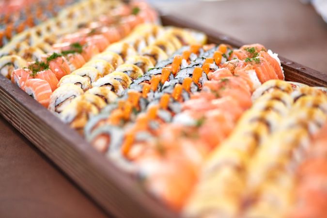 Set of delicious sushi on wooden board