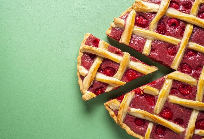 Raspberry pie with one slice and lattice crust. Classic dessert