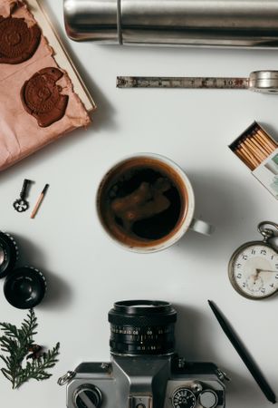 Creative arrangement of vintage items on desk with coffee