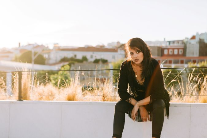 Trendy female standing on urban background