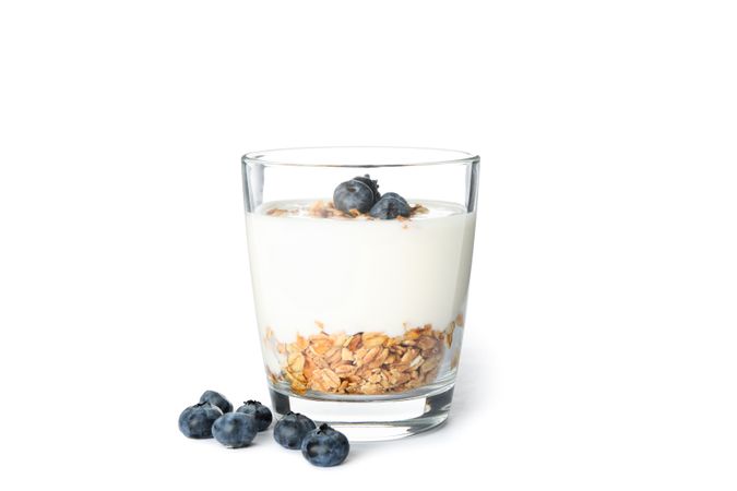 Parfait dessert in glass isolated on light background