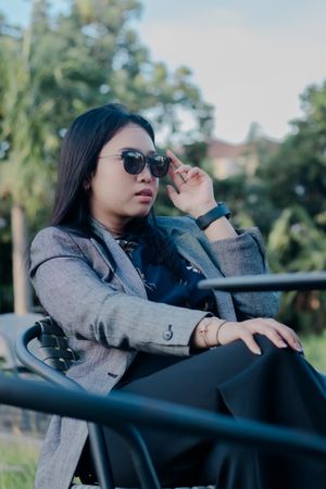 Confident Asian Woman in Stylish Attire Enjoying Outdoor Leisure