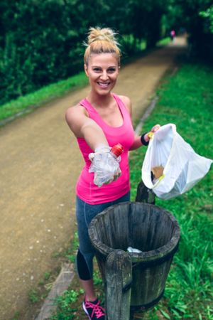 Woman showing garbage after picking up litter