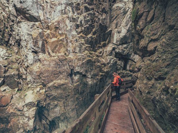 Traveller admiring picturesque view of mountain ridge