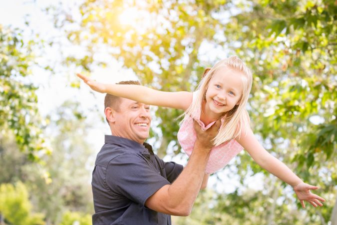 Young Father and Daughter Having Fun At The Park