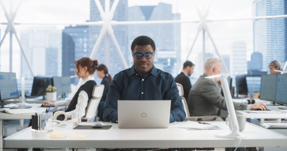 Cheerful Male Programmer Coding In Modern Fintech Startup Workspace, Engineering Software