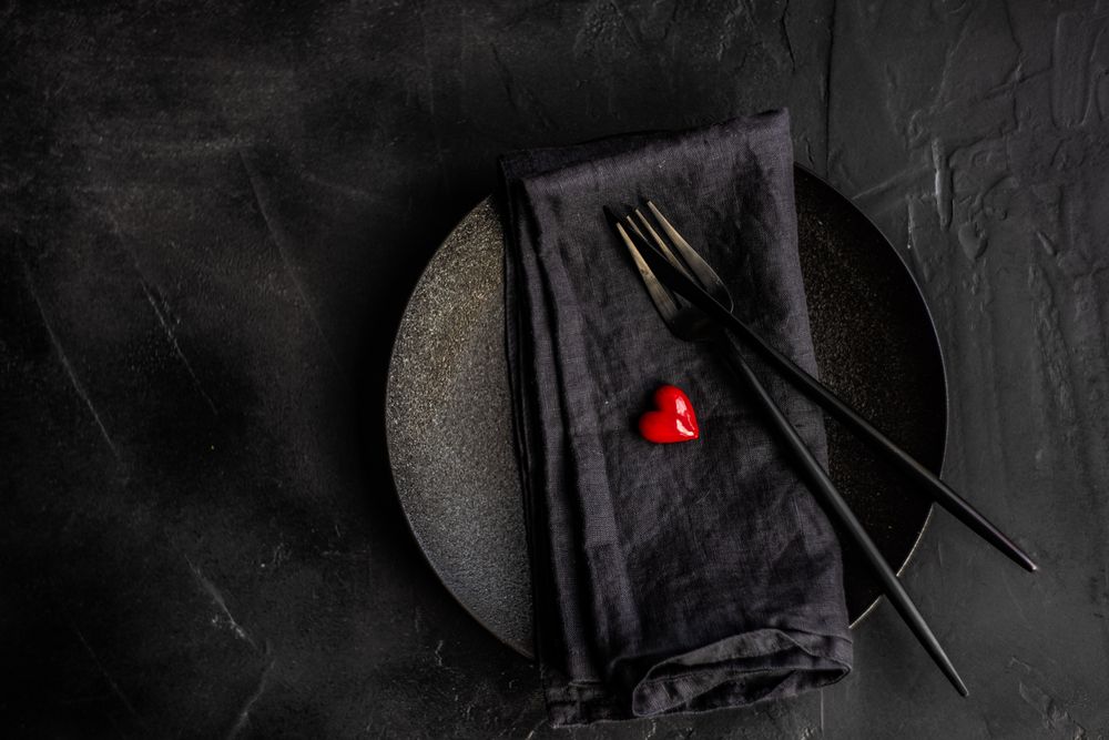 Dark St. Valentine's day table setting with red heart