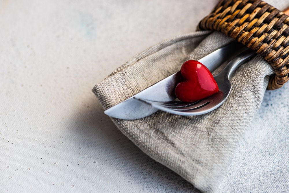 St Valentine day table setting with small red heart and napkin ring