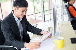 Male employee looking at documents in the office