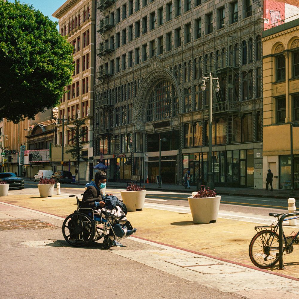 Man with facemask on wheelchair outdoor