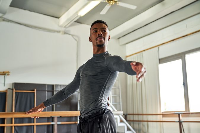 Black male dancer in a warm-up and dancing in a ballet class