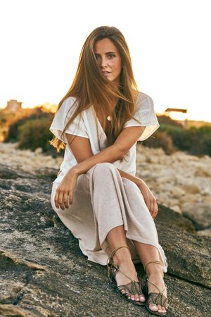 young woman posing on rock