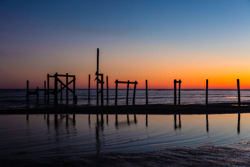 Pier pilings at dusk along the Gulf of Mexico, Hancock County, Mississippi
