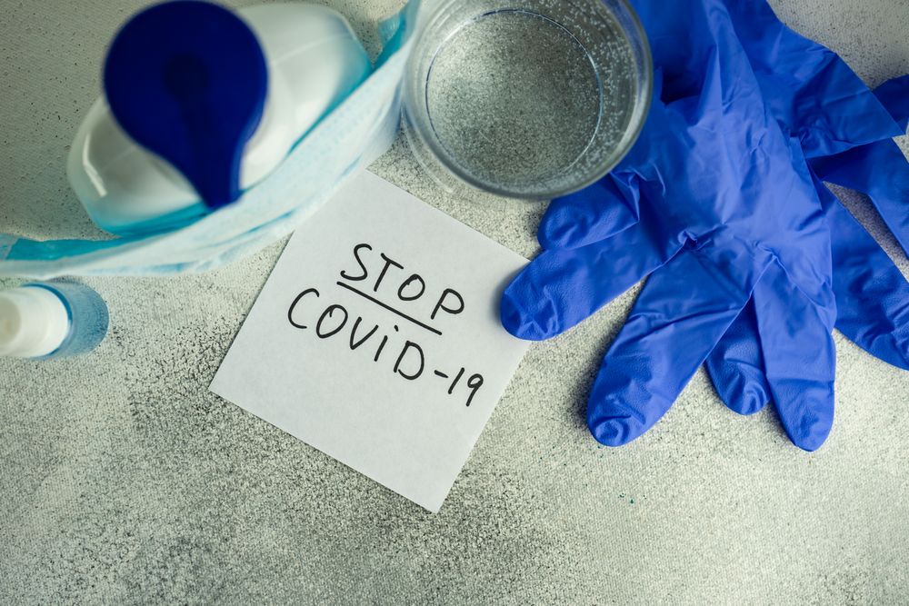 Top view of latex gloves, glass of water and soap in health care concept