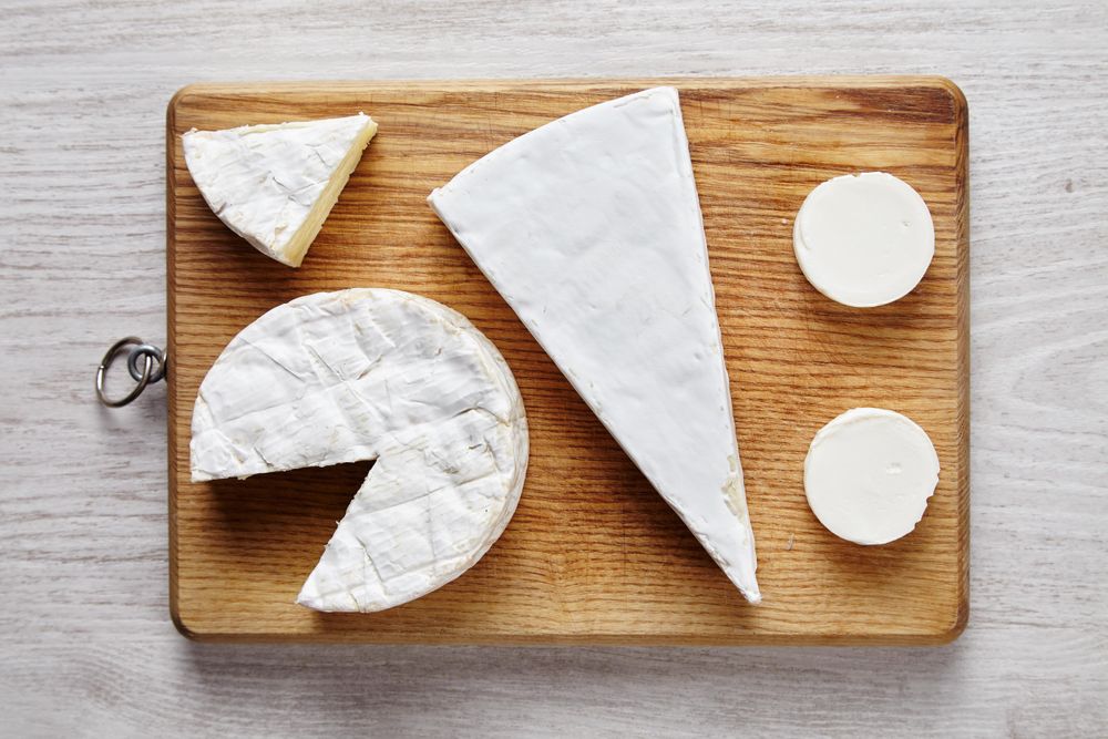 Assortment of cheese on bread board
