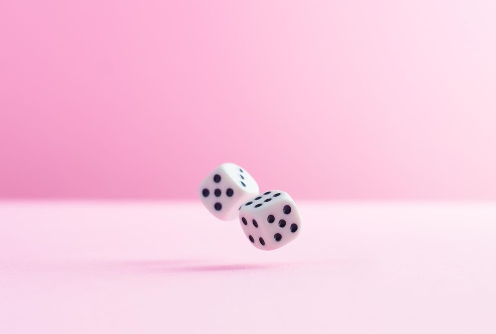 Two dice over pink background