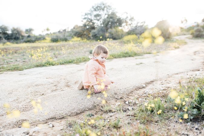 Adorable toddler girl on roadside