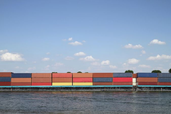 Cargo containers on the river Rhine under blue sky