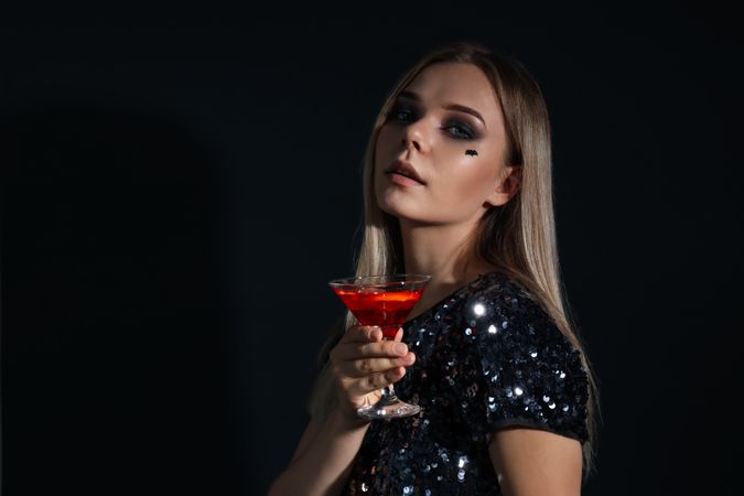 Concept of Halloween, young woman on dark background