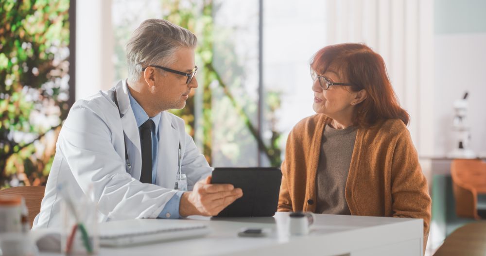 Physician Talking with a Woman During Consultation in Health Clinic