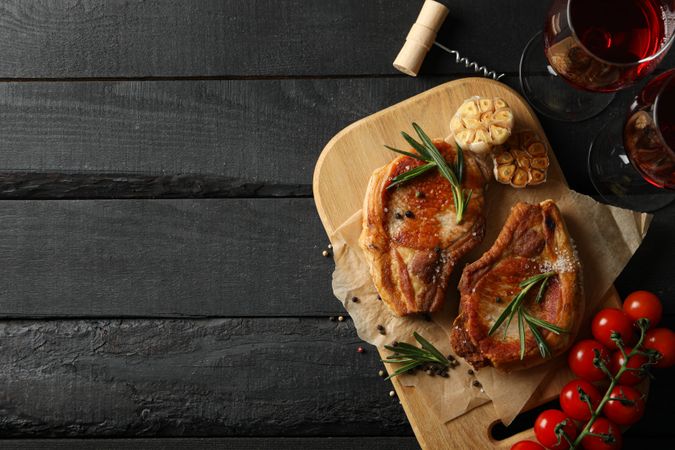Composition with fried steaks and wine. Grilled food