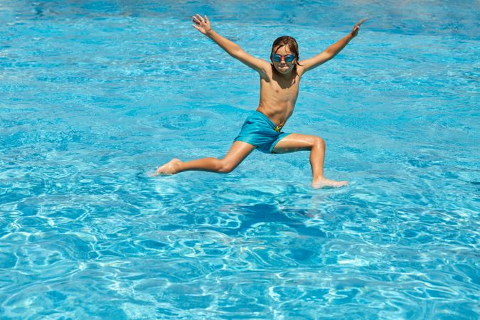 Kid jumping in swimming pool