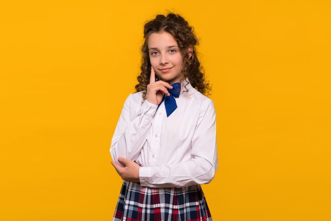 Girl touching chin, thoughtful expression