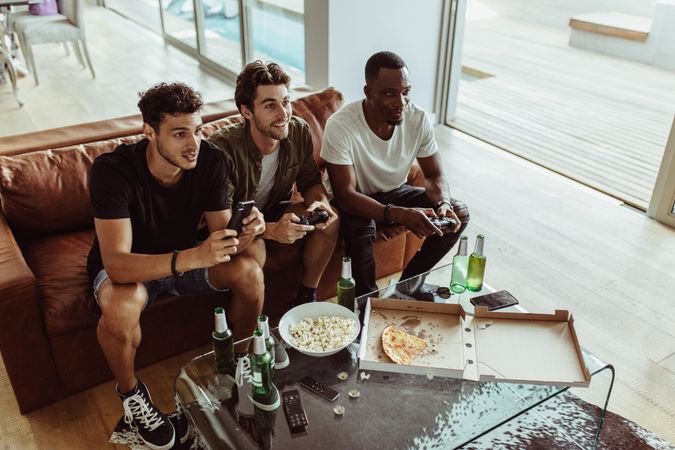 Friends having fun at home playing video games