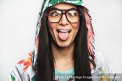 Woman pictured in colorful printed floral hoodie and glasses making a funny face for the camera 4dYGlb