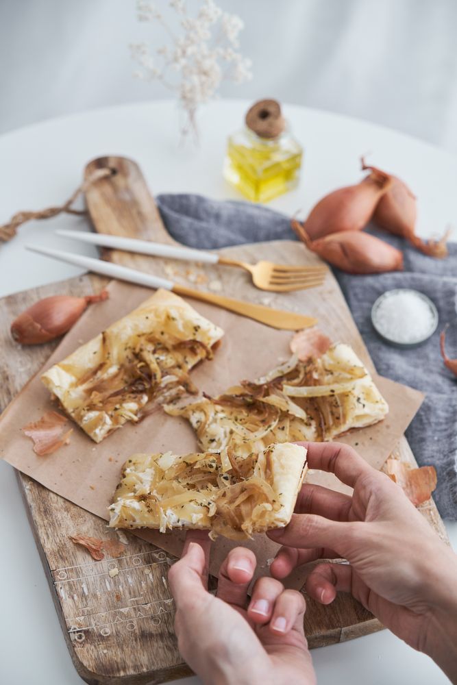 Faceless person with baked onion tart