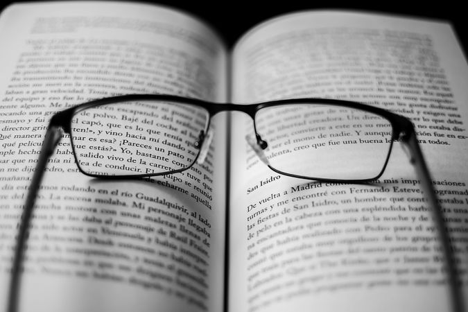 Framed eyeglasses on book pages