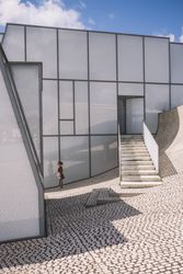 Woman next to contemporary building