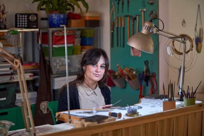 Charming woman working in creative workshop