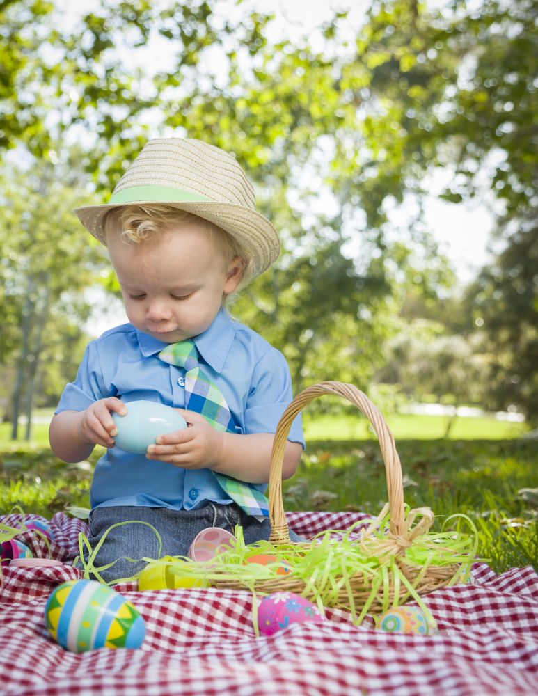 Cute Little Boy Enjoying His Easter Eggs Outside in Park